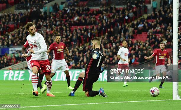 Manolo Gabbiadini of Southampton shoots past goalkeeper David De Gea of Manchester United to score their first goal during the EFL Cup Final between...