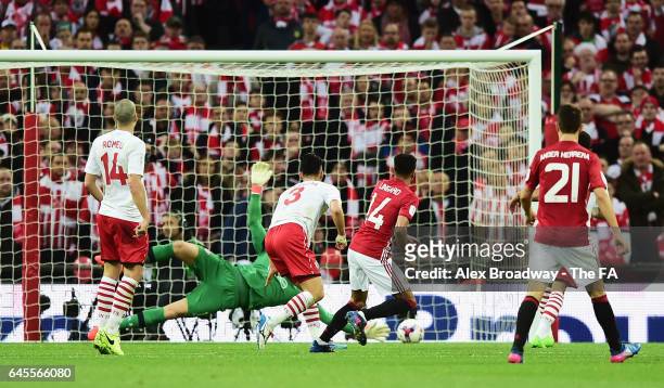 Jesse Lingard of Manchester United shoots past Maya Yoshida and Fraser Forster of Southampton to score their second goal during the EFL Cup Final...