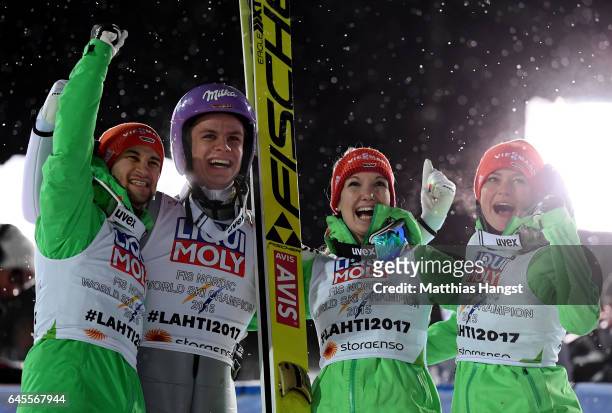 Andreas Wellinger of Germany celebrate with his team mates after landing his second jump in the Mixed Team HS100 Normal Hill Ski Jumping during the...