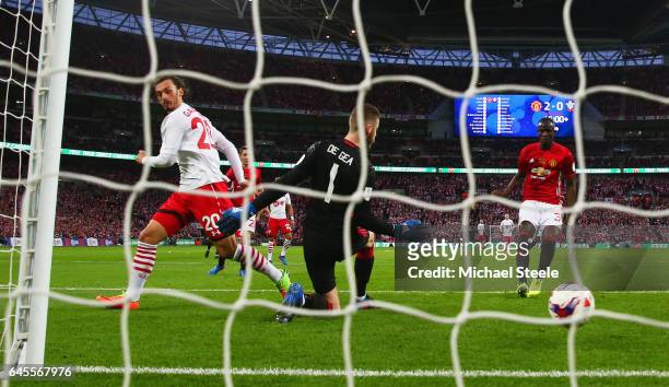 Manolo Gabbiadini of Southampton shoots past goalkeeper David De Gea of Manchester United to score their first goal during the EFL Cup Final between...