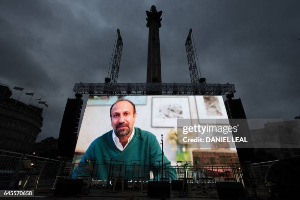 Iranian filmmaker Asghar Farhadi speaks in a recorded video message during the public screening for the film 'The Salesman' in Trafalgar Square in...