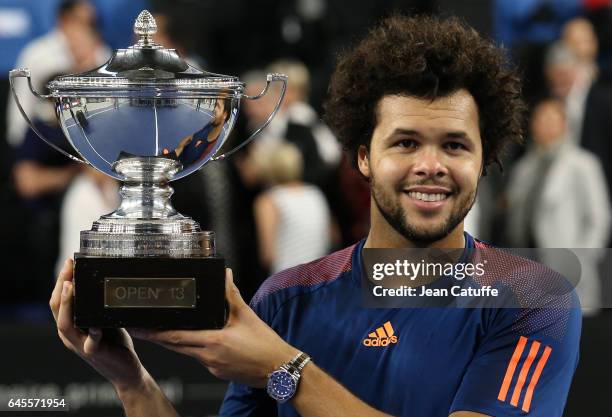 Jo-Wilfried Tsonga of France holds the trophy after beating Lucas Pouille of France in the final of the Open 13, an ATP 250 tennis tournament at...