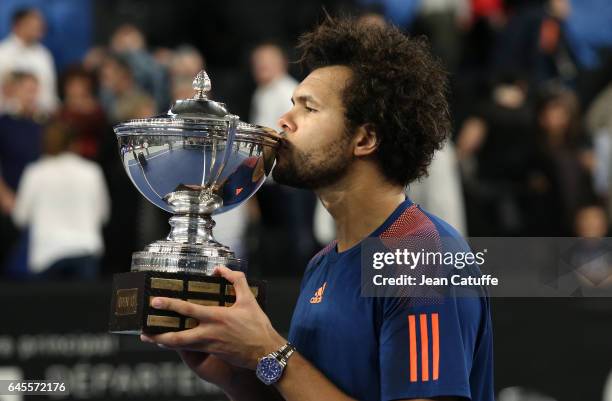 Jo-Wilfried Tsonga of France holds the trophy after beating Lucas Pouille of France in the final of the Open 13, an ATP 250 tennis tournament at...