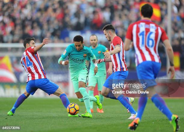 Neymar of FC Barcelona dribbles the ball past Gabi Fernandez of Club Atletico de Madrid during the La Liga match between Club Atletico de Madrid and...