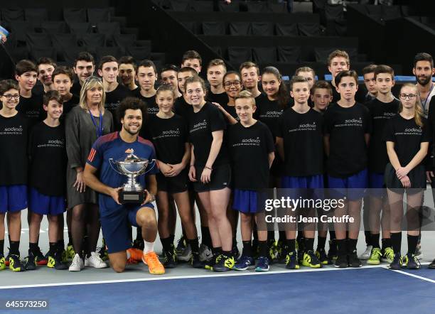 Winner Jo-Wilfried Tsonga of France poses with the trophy with the ball boys and girls following the final at the Open 13, an ATP 250 tennis...