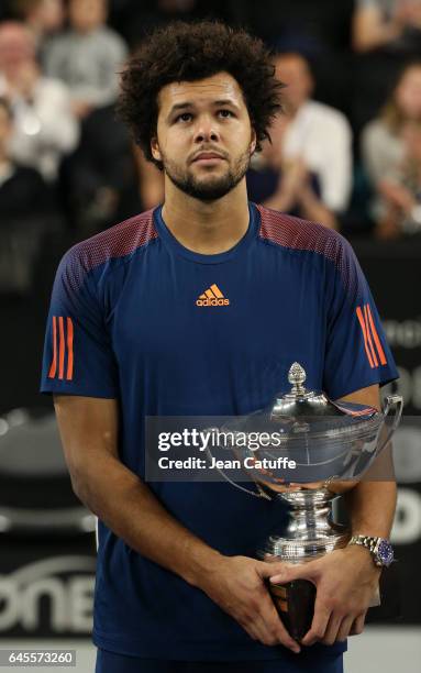 Jo-Wilfried Tsonga of France holds the trophy after beating Lucas Pouille of France in the final of the Open 13, an ATP 250 tennis tournament at...