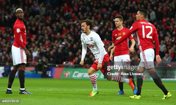 Manolo Gabbiadini of Southampton celebrates as Paul Pogba , Ander Herrera and Chris Smalling of Manchester United look dejected as he scores their...