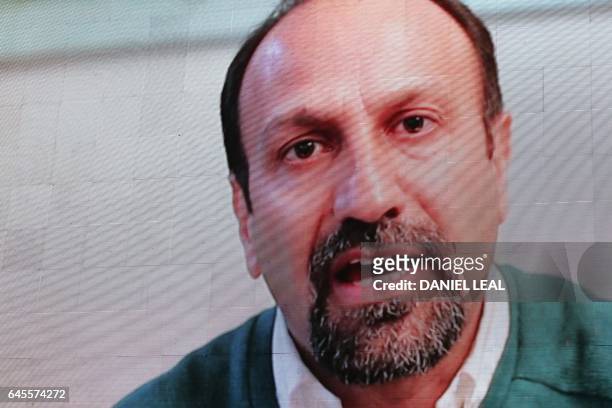 Iranian filmmaker Asghar Farhadi speaks in a recorded video message during the public screening for the film 'The Salesman' in Trafalgar Square in...