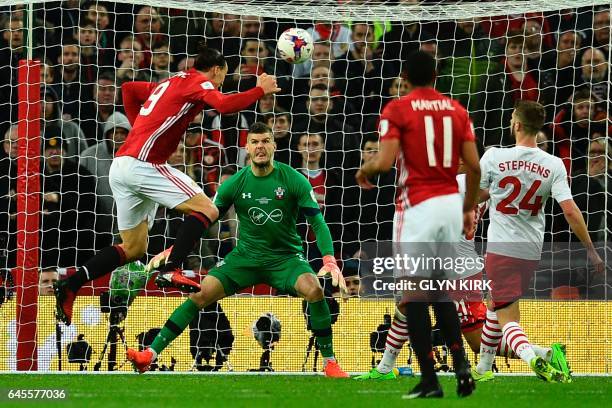 Manchester United's Swedish striker Zlatan Ibrahimovic jumps to head their third goal past Southampton's English goalkeeper Fraser Forster during the...