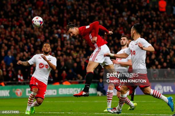 Manchester United's Swedish striker Zlatan Ibrahimovic jumps to head their third goal during the English League Cup final football match between...