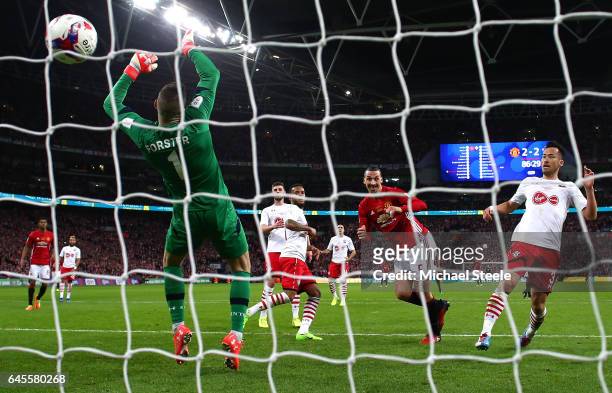 Zlatan Ibrahimovic of Manchester United scores their third goal past goalkeeper Fraser Forster of Southampton during the EFL Cup Final between...