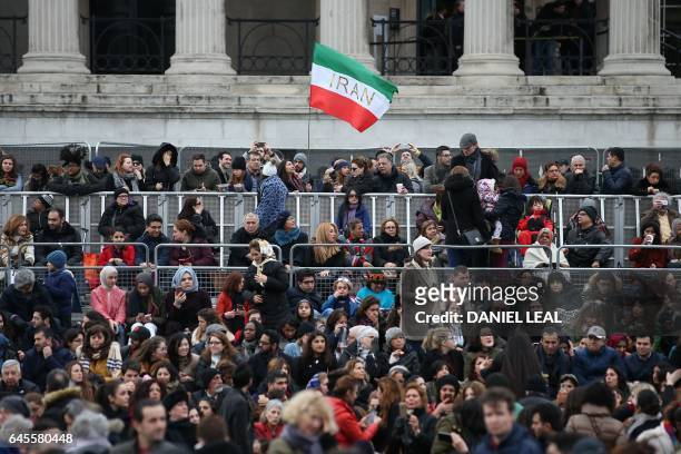An Iranian flag flies as people gather in Trafalgar Square for the public screening for the film 'The Salesman' in central London on February 26,...
