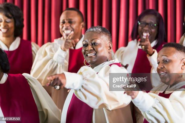 mature black women and men singing in church choir - gospel choir stock pictures, royalty-free photos & images