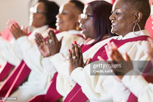 group of mature black women in church robes - gospel choir stock pictures, royalty-free photos & images