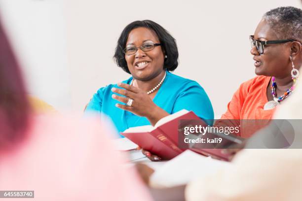 two black women in bible study group - round table discussion stock pictures, royalty-free photos & images