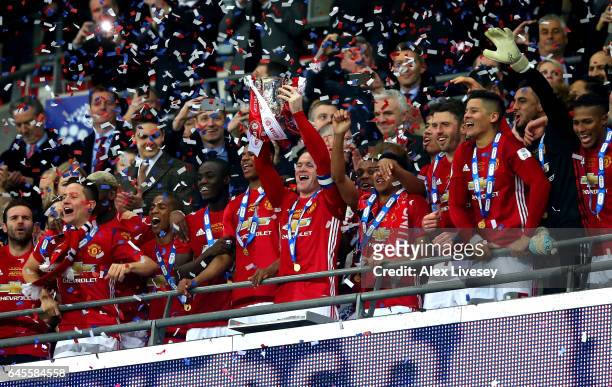 Wayne Rooney of Manchester United lifts the EFL trophy with teammates after the EFL Cup Final match between Manchester United and Southampton at...