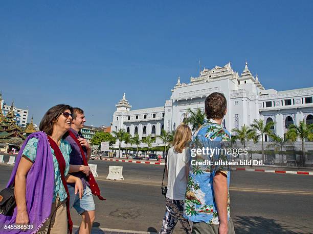 Tourists walk past the City Hall in Yangon, Myanmar