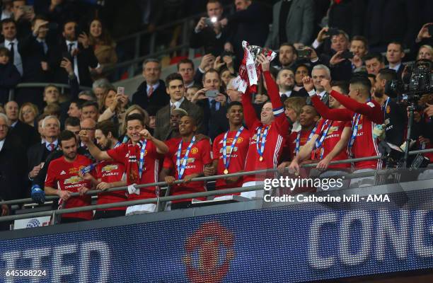 Wayne Rooney of Manchester United lifts the trophy as the team celebrate during the EFL Cup Final match between Manchester United and Southampton at...