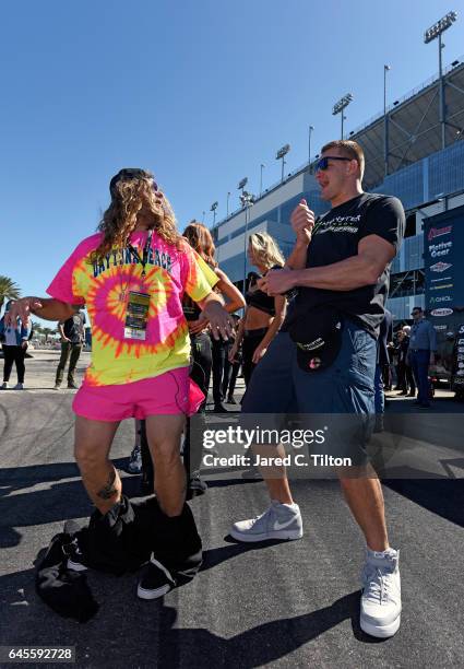 New England Patriots tight end Rob Gronkowski interacts with a fan prior to the 59th Annual DAYTONA 500 at Daytona International Speedway on February...