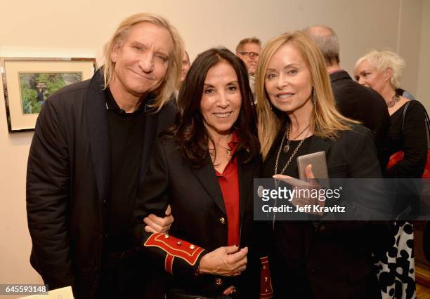 Singer-songwriter Joe Walsh of The Eagles, author Olivia Harrison, and Marjorie Bach attend the "I ME MINE" George Harrison book launch at Subliminal...