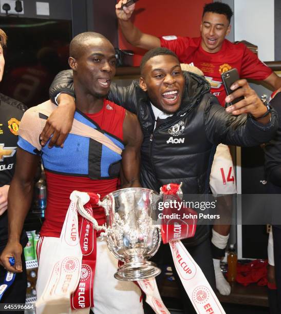 Eric Bailly and Timothy Fosu-Mensah of Manchester United celebrate in the dressing room after the EFL Cup Final match between Manchester United and...