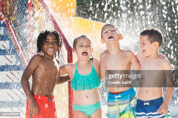 multi-ethnic children at a water park - waterslide stock pictures, royalty-free photos & images