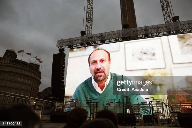 Iranian film director Asghar Farhadi is seen in a video message before a free screening and UK premier of The Salesman in Trafalgar Square on...