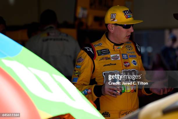 Kyle Busch, driver of the M&M's Toyota, stands in the garage area after being involved in an on-track incident during the 59th Annual DAYTONA 500 at...