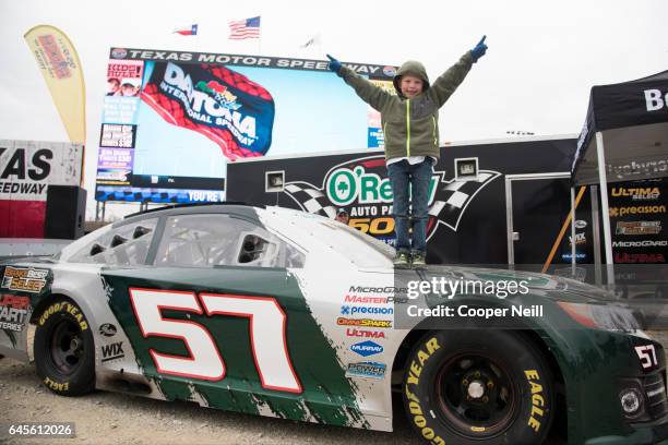Fans check out the O'Reilly Auto Parts car before watching the Daytona 500 on the world's largest TV, Big Hoss, at Texas Motor Speedway on February...