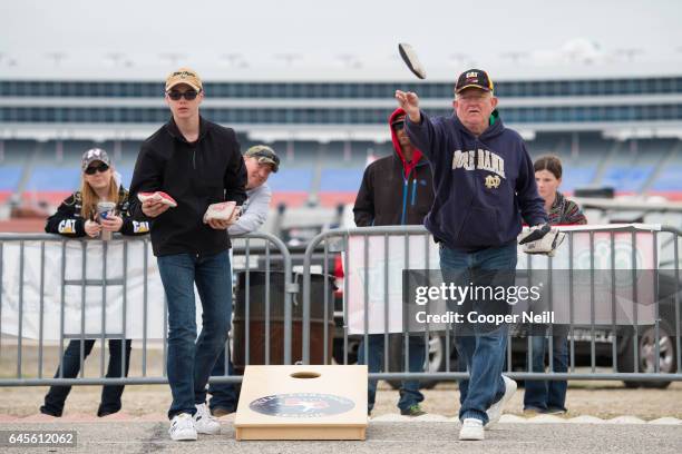 Fans compete in a cornhole tournament before watching the Daytona 500 at Texas Motor Speedway on February 26, 2017 in Fort Worth, Texas.