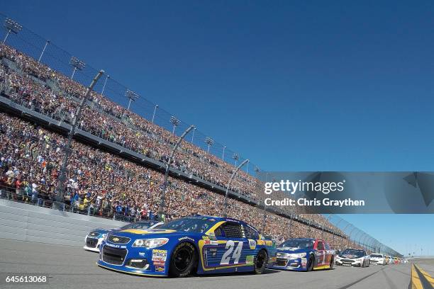 Dale Earnhardt Jr., driver of the Nationwide Chevrolet, and Chase Elliott, driver of the NAPA Chevrolet, lead the field prior to the 59th Annual...