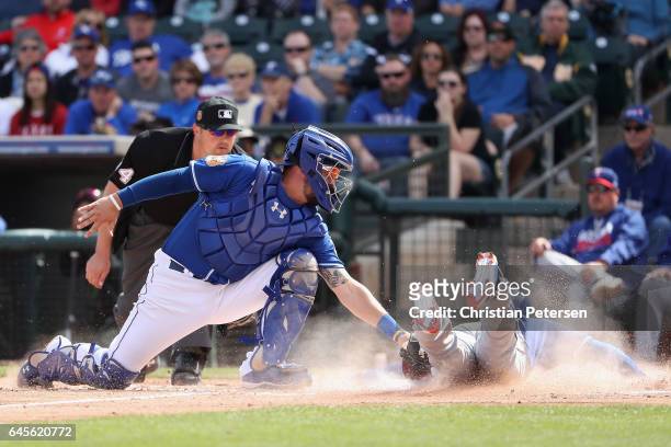 Jurickson Profar of the Texas Rangers safely slides into home plate to score a run past catcher Cam Gallagher of the Kansas City Royals during the...