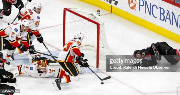 Carolina Hurricanes' Jeff Skinner looks back after he failed to score against the Calgary Flames' TJ Brodie , Michael Stone , Brian Elliott and Sean...