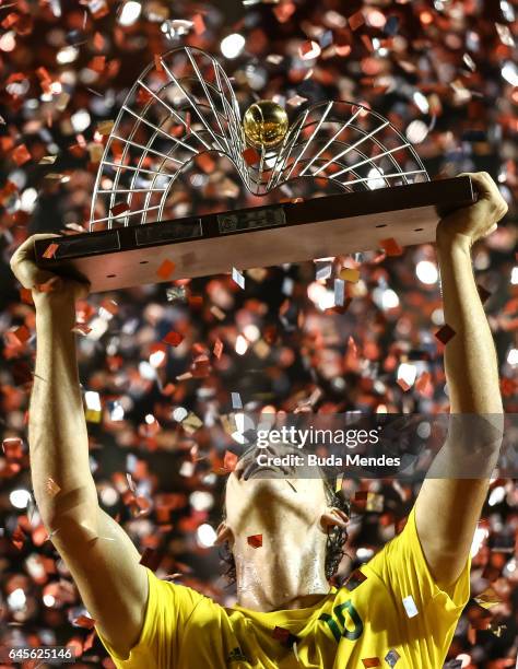 Dominic Thiem of Austria raises his trophy after defeating Pablo Carreno Busta of Spain during the Final of the ATP Rio Open 2017 at Jockey Club...