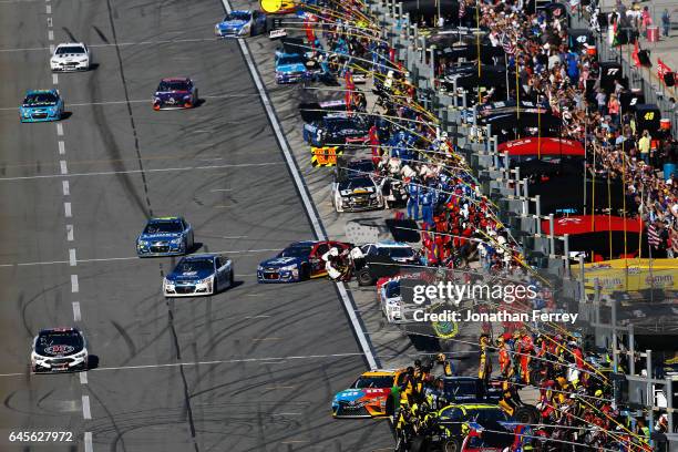 Cars pit during the 59th Annual DAYTONA 500 at Daytona International Speedway on February 26, 2017 in Daytona Beach, Florida.