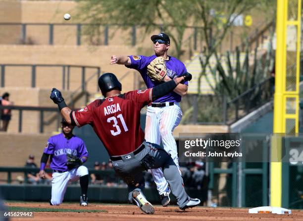 Arizona Diamondbacks center fielder Oswaldo Arcia is forced at second base as Colorado Rockies second baseman DJ LeMahieu throws over to first base...