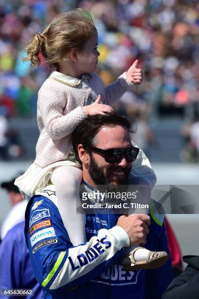 Jimmie Johnson, driver of the Lowe's Chevrolet, and his daughter Lydia Norriss walk the grid prior to the 59th Annual DAYTONA 500 at Daytona...