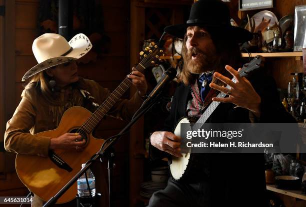 Susie Knight, a poet and western singer, left, sings 1880's style songs with singer Rex Rideout, right, during the 100th anniversary celebrations of...