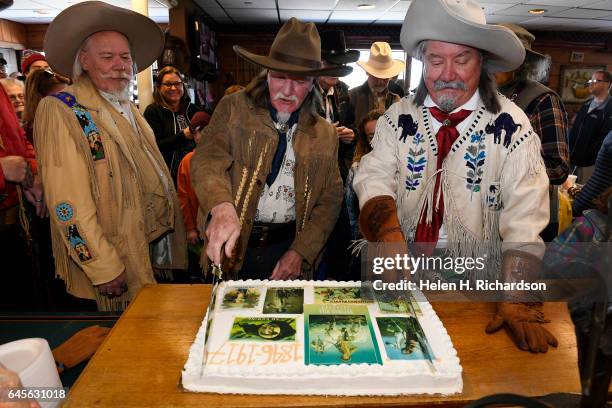 Buffalo Bill impersonators from left to right Buzz Baker, Stanley Beug and RD Melfi, right, get ready to cut the cake during the 100th anniversary of...