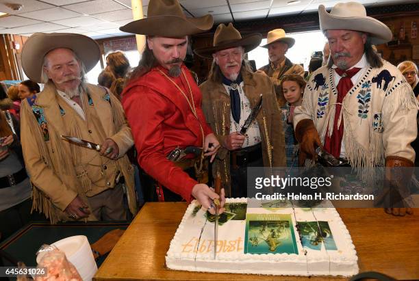 Buffalo Bill impersonators from left to right Buzz Baker, Jason Baker, Stanley Beug, second from right and RD Melfi, right, cut the anniversary cake...