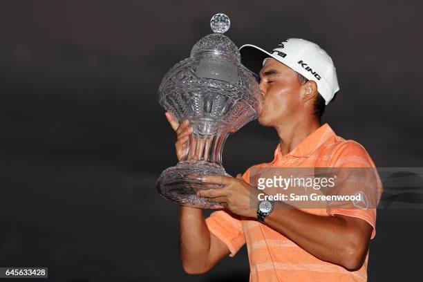 Rickie Fowler of the United States celebrates with the winner's trophy after the final round of The Honda Classic at PGA National Resort and Spa on...