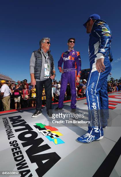 Motor racing legend Mario Andretti talks with Denny Hamlin, driver of the FedEx Express Toyota, and Dale Earnhardt Jr., driver of the Nationwide...