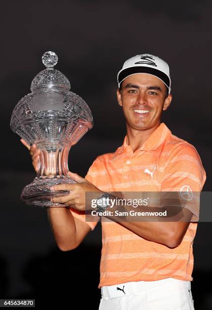 Rickie Fowler of the United States celebrates with the winner's trophy after the final round of The Honda Classic at PGA National Resort and Spa on...