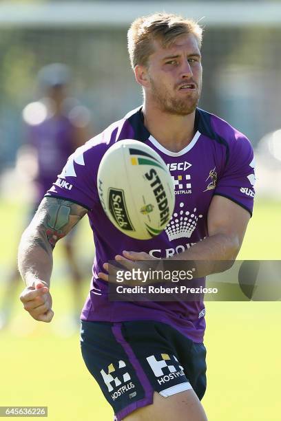 Cameron Munster offloads the ball during the Melbourne Storm NRL training session at Gosch's Paddock on February 27, 2017 in Melbourne, Australia.