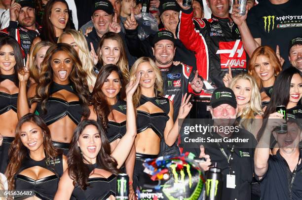 Kurt Busch, driver of the Haas Automation/Monster Energy Ford, celebrates in Victory Lane with Monster Energy Girls after winning the 59th Annual...