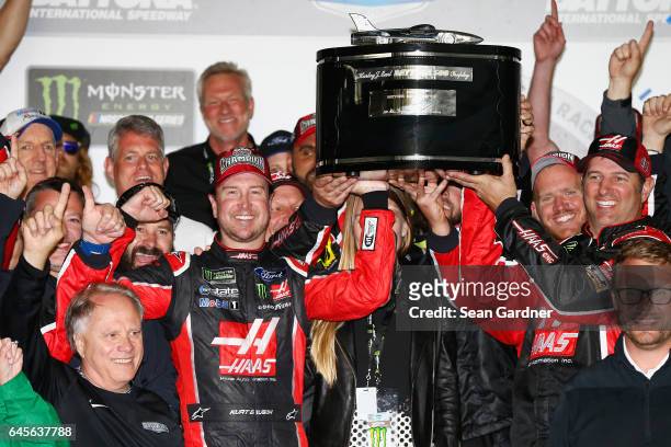 Kurt Busch, driver of the Haas Automation/Monster Energy Ford, celebrates with the trophy in Victory Lane after winning the 59th Annual DAYTONA 500...