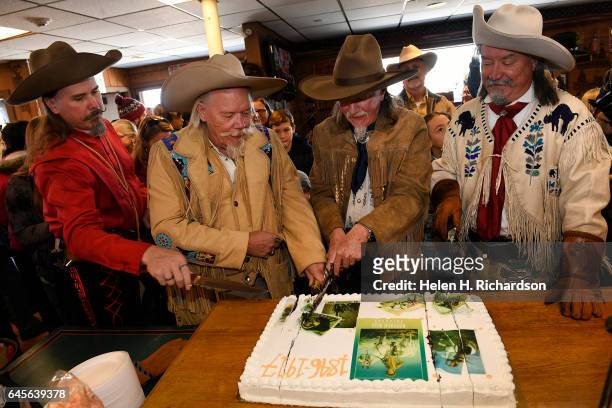 Buffalo Bill impersonators from left to right Jason Baker, Buzz Baker, Stanley Beug, second from right and RD Melfi, right, cut the anniversary cake...