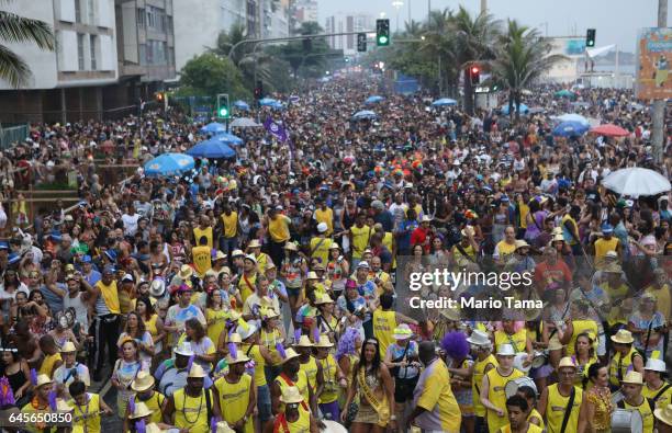 Revelers mach at the Simpatia e Quase Amor 'bloco', or street party, on the third official day of Carnival along Ipanema beach on February 26, 2017...