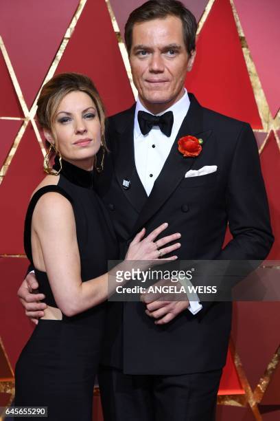 Nominee for Best Supporting Actor in "Nocturnal Animals" Michael Shannon and his partner Kate Arrington pose as they arrive on the red carpet for the...