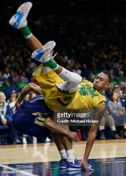 Bonzie Colson of the Notre Dame Fighting Irish tumbles with Tadric Jackson of the Georgia Tech Yellow Jackets at Purcell Pavilion on February 26,...